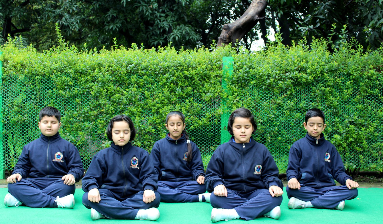 Child in peaceful meditation in classroom